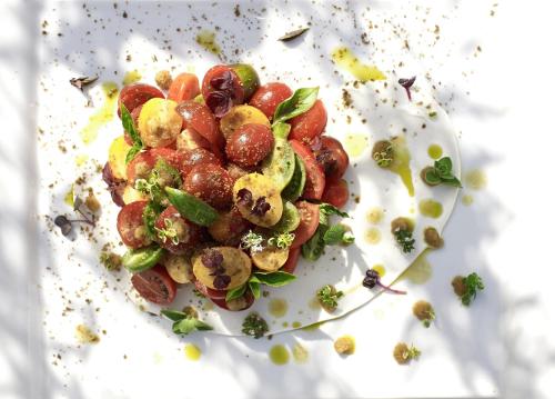 a plate of food with grapes and other vegetables at Sani Club in Sani Beach