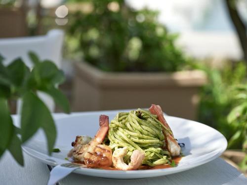 a plate of food with shrimp and zucchini at Sani Club in Sani Beach