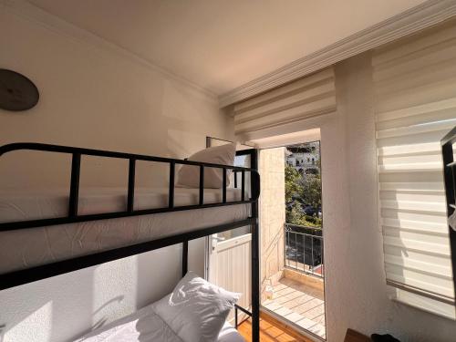 a bedroom with a bunk bed and a balcony at Göreme Hostel in Goreme