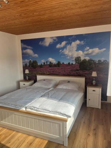 a bedroom with a bed with a painting on the wall at Ferienwohnung Olendorp in Hermannsburg