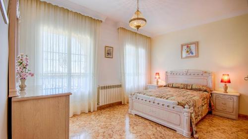 a bedroom with a white bed and a large window at Castillo de la Hazalara Cómpeta by Ruralidays in Cómpeta