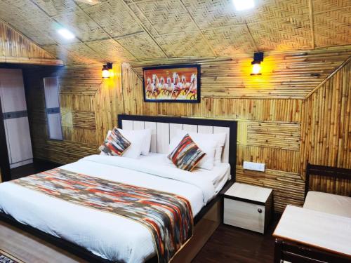 a bedroom with a bed in a room with wooden walls at Hotel Arcadia plutus in Jaipur