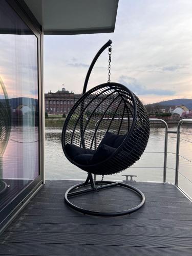 a swing chair sitting on the deck of a boat at L'Escale Royale Saverne - Rhin - Strasbourg in Saverne