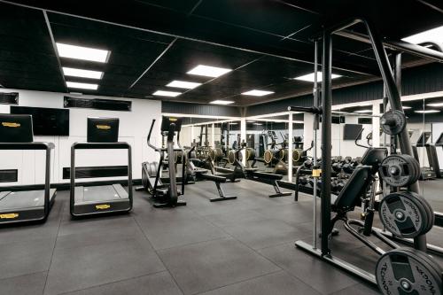 a gym with several treadmills and machines in it at InterContinental Wellington by IHG in Wellington