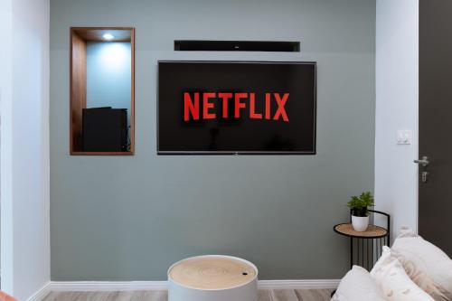 a netflix sign on a wall in a living room at BarraZen-Lofts-2-Netflix in Cayenne