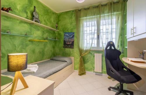 a green room with a bed and a desk and a chair at Green House in Monopoli