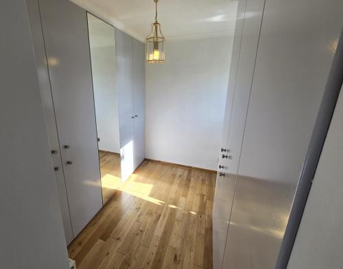 an empty room with a mirror and a hallway at Ard Veich Estate - Panoramic Highland Sea Views with private beach and woodland in Port Appin