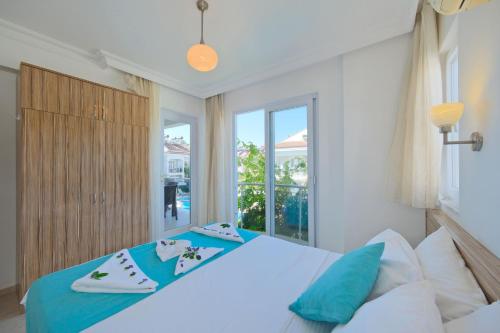 a bedroom with a bed and a large window at Legend Apartments II Fethiye in Fethiye