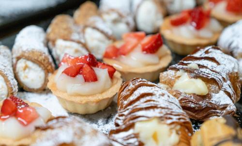 a bunch of pastries with strawberries on a tray at Hotel Mondolé - Azzurro Club in Prato Nevoso