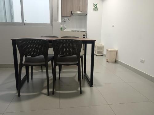 a dining room table with chairs in a kitchen at Hotel La Libertad - Ayacucho in Ayacucho