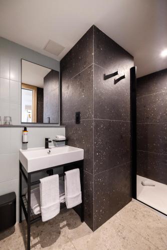 a bathroom with a sink and a shower at Hotel Levante St Julian's, Affiliated by Melia in St Julian's