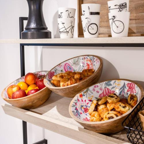 three bowls of bread and apples on a shelf at Hotel Levante St Julian's, Affiliated by Melia in St Julian's