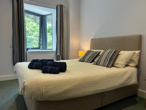a bedroom with a large bed with blue towels on it at Harbour Stays - The Marine Centre, Saundersfoot Harbour, SA69 9HE in Saundersfoot