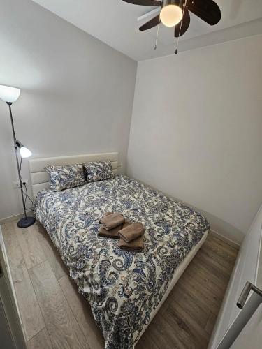 a bedroom with a bed with a pillow and a fan at Apartamentai in Palanga