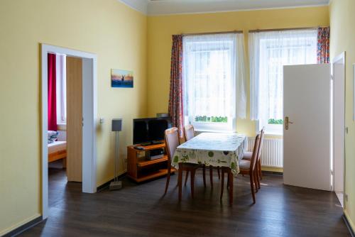a dining room with a table and chairs at Villa Regina Waldblick in Friedrichroda