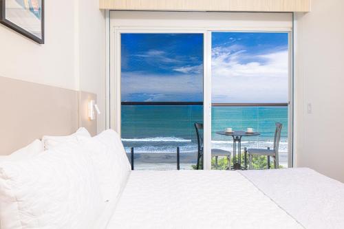 a bedroom with a bed and a view of the ocean at Radisson Riviera Panama in Punta Chame