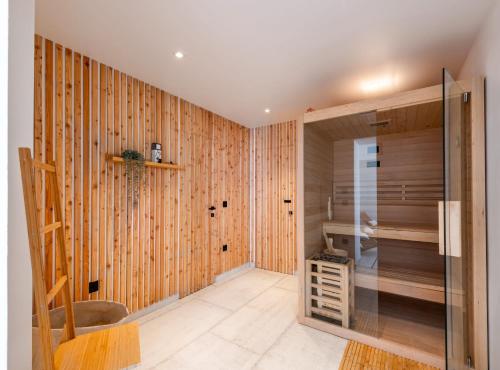 a bathroom with wood paneled walls and a walk in shower at Luxury B.one Apartment in Cavtat