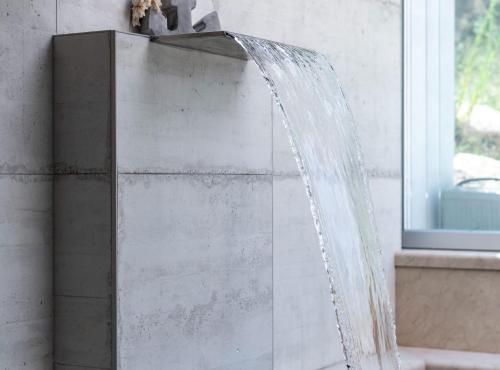 a water fountain in a bathroom next to a window at Luxury Private Spa Apartment with Heated Pool & Sauna and Sea View in Cavtat