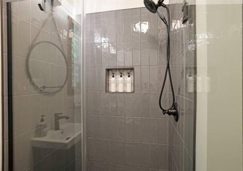 a bathroom with a shower and a sink at Tiny Tarheel Cozy Retreat Near UNC Tiny House in Chapel Hill