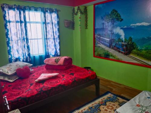 a bedroom with a bed with a painting on the wall at Kabiraalaya Homestay in Darjeeling