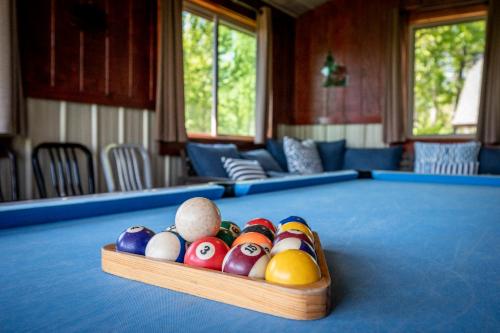 a tray of billiard balls sitting on top of a pool table at Grand View in Rocky Grove
