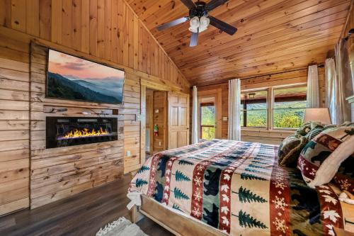 a bedroom with a fireplace in a log cabin at Grand View in Rocky Grove