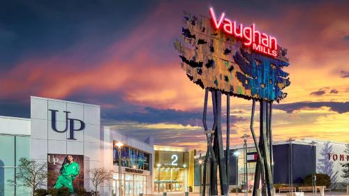 a large sign in front of a shopping center at Holiday Inn Express Toronto-North York by IHG in Toronto