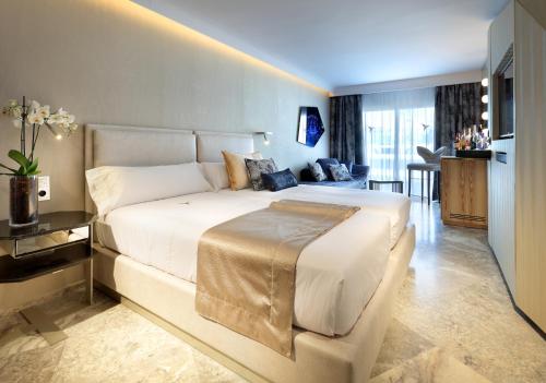 a bedroom with a large white bed in a room at Ushuaïa Ibiza Beach Hotel - Adults Only - Club Entrance Included in Playa d'en Bossa