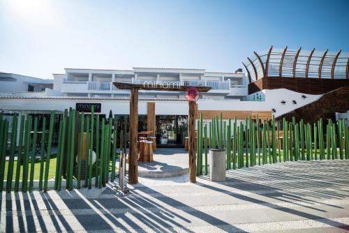 a building with green gates in front of it at Ushuaïa Ibiza Beach Hotel - Adults Only - Club Entrance Included in Playa d'en Bossa