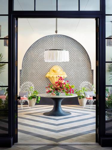 a table with a pie on it with flowers on it at The Goodtime Hotel, Miami Beach a Tribute Portfolio Hotel in Miami Beach