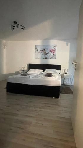 a large bed in a room with at OASE im grünen Hinterhof, EG, Ruhe, Terrasse, Carport, free PayTV, Kaffee&Tee, Fahrräder in Duisburg