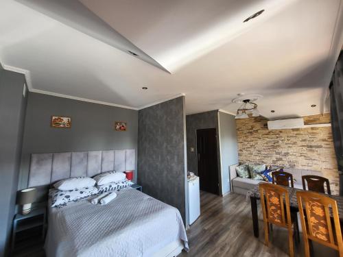 a bedroom with a bed and a brick wall at Willa Rudnik in Grudziądz