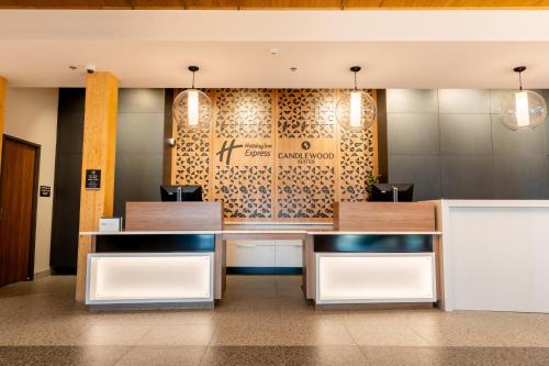 a lobby of a hotel with a sign on the wall at Holiday Inn Express & Suites - Trois Rivieres Ouest by IHG in Trois-Rivières