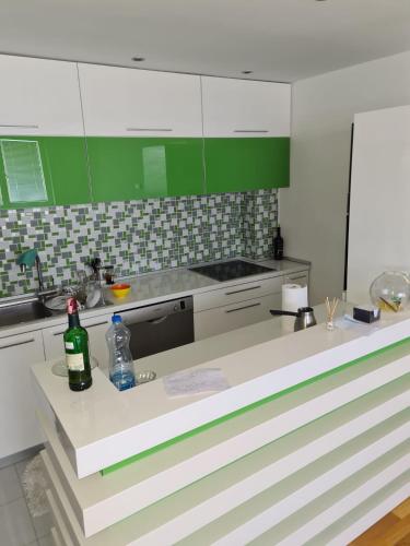 a kitchen with a counter with a bottle of wine at Villa Kale Luxury in Skopje