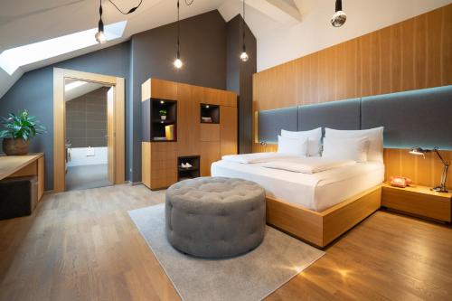 a bedroom with a large bed and a large ottoman at INNSiDE by Meliá Prague Old Town in Prague