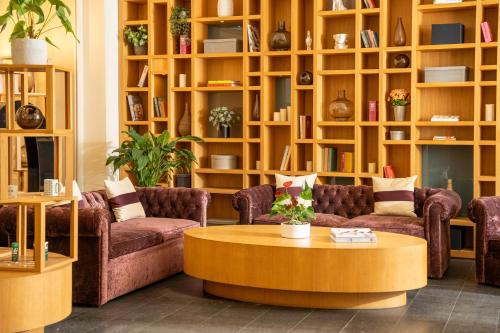 a living room with couches and a coffee table at INNSiDE by Meliá Prague Old Town in Prague