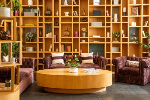 a living room with couches and a coffee table at INNSiDE by Meliá Prague Old Town in Prague