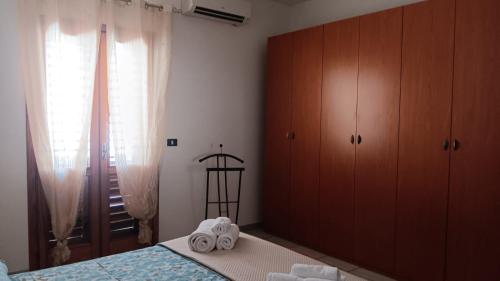 a bedroom with a bed with towels on it at SWEET Apartment in San Giorgio Ionico
