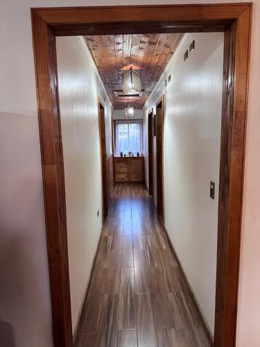 a hallway in a house with wooden floors and a ceiling at Tranquilidad y descanso en Villarrica - Pucón in Pucón