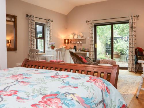 a bedroom with a bed and a living room at Pink Granite Garden of Ireland in Killicreny Bridge