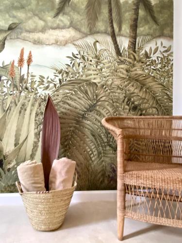 a wall mural in a room with a basket and a chair at Luxury Lions Villas Zanzibar - with Private Cook&Infinity Pools in Kiwengwa