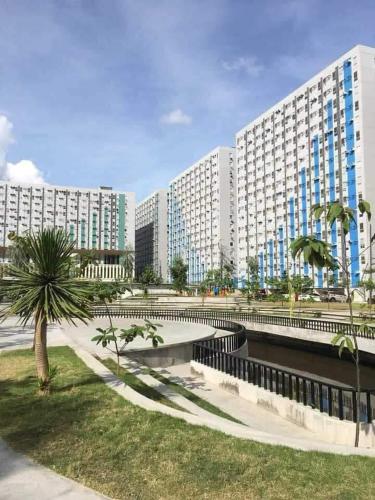 a large building with palm trees in front of it at La Casa De Lita in Manila