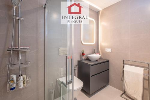 a bathroom with a toilet and a sink and a shower at Apartament Mar Blau in Palamós