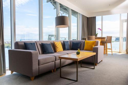 a living room with a couch and a table at voco St. David's Cardiff by IHG in Cardiff