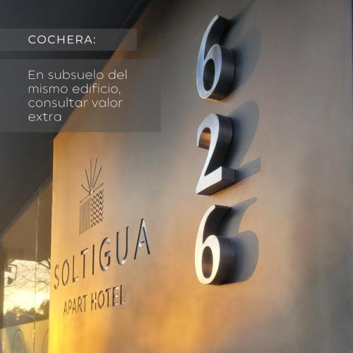 a sign with the number six on a wall at Soltigua Apart Hotel Mendoza in Mendoza
