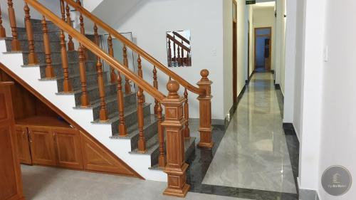 a staircase with wooden railings in a house at Vy An Hotel in Bao Loc