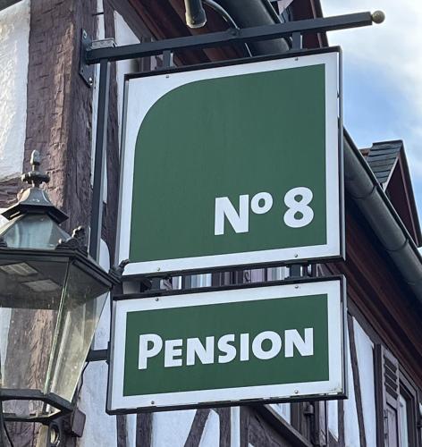 a street sign for no and a sign for permission at Pension No8 in Bad Vilbel