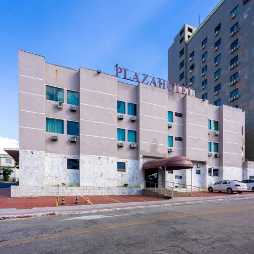 a hotel building with a sign on top of it at Plaza Hotel São José dos Campos in São José dos Campos