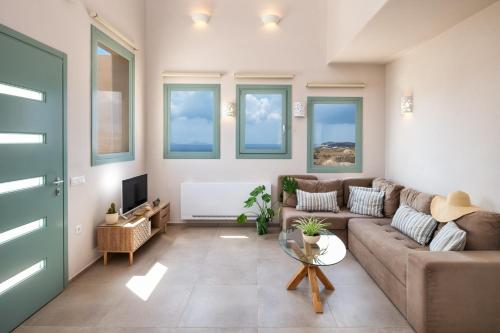 a living room with a couch and a table at Dune Santorini Villa in Vlychada