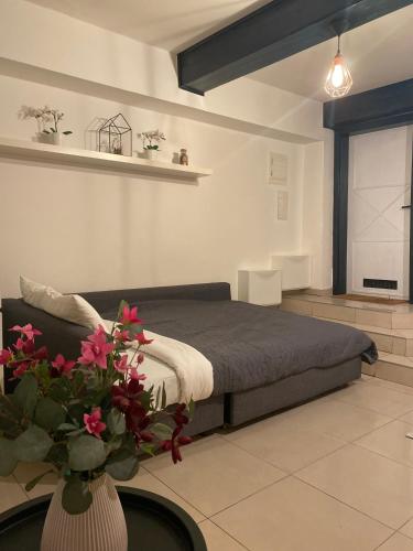 a bedroom with a bed and a vase with flowers at Center underground studio in Bratislava